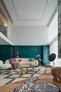 Modern living room with a metal and glass architecture, fabric upholstery, and a carpet floor.