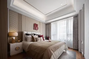 A modern bedroom featuring neutral-toned fabrics and textured wall paneling.