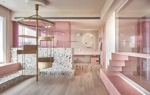 An elegant minimalist interior with pink terrazzo flooring and white wood accents.