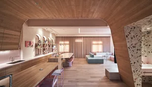 A modern living room featuring wood flooring and wooden furniture.