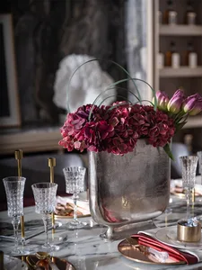 A photograph of an industrial-style interior design featuring metallic and glass elements.