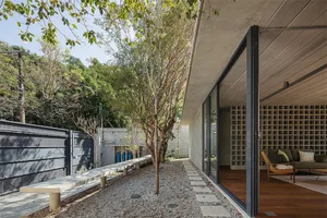 A modern minimalist home with a concrete interior design featuring concrete walls and floors, natural lighting, and a clean, 