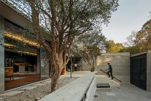 Modern interior design featuring a concrete and glass house with a garden.