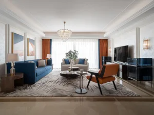 Well-furnished modern living room with blue sofa and orange armchair.