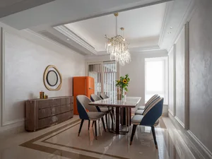Modern dining room with marble flooring, chairs, and table.