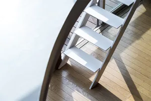 A modern steel staircase with white steps illuminated by sunlight.