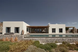 Modern minimalist residential exterior featuring concrete and stone materials.