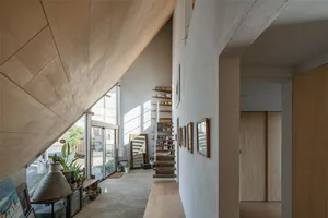 Modern minimalist interior with wood, concrete, and brick materials.
