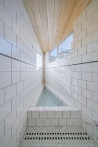 Modern minimalist bathroom with white tile walls and floor
