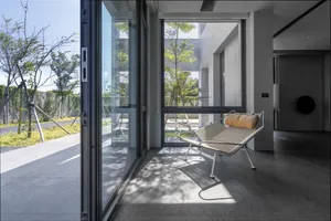 Modern minimalist living room featuring a glass sliding door.