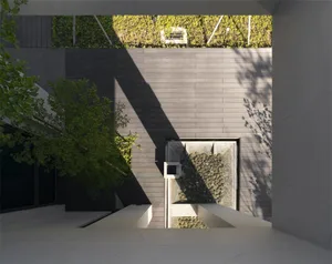 Modern architectural design featuring concrete and glass materials.