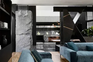 A modern living room featuring black marble and stone accents