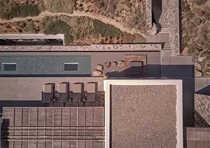 Aerial view of a modern residential space featuring a concrete and stone exterior and interior.