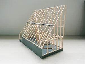 A detailed architectural model depicting a house made of wood.