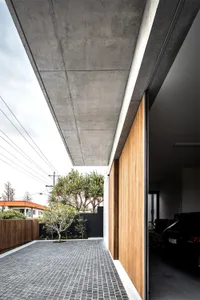 Concrete and wooden modern residential entryway.