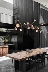 Modern industrial dining space featuring a wooden table and concrete floor.