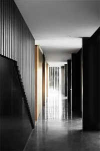 An image of a minimalist hallway featuring concrete and wood materials.