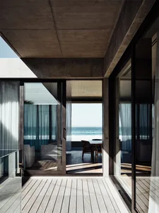 Modern apartment with floor-to-ceiling windows overlooking the ocean