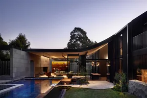Modern house featuring stone, brick, and glass elements.