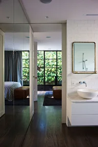 Modern bathroom with white tiled walls and a minimalist design.