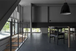 Modern residential dining room featuring concrete flooring and minimalist design.