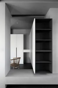 Modern interior design featuring a minimalist space with concrete walls and wooden furniture.