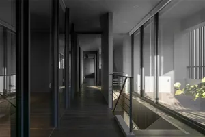 A modern interior hallway with glass walls and dark wooden flooring.