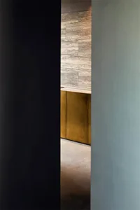 A minimalist interior designed with ceramic tiles on the walls and floor.