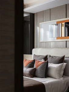 Modern bedroom featuring upholstered furniture and textiles
