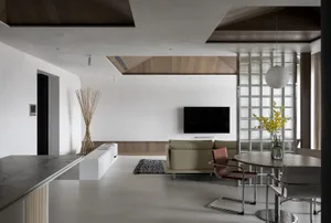 A modern minimalist living room with white walls and wooden elements, featuring a white sofa, wooden coffee table, and minima