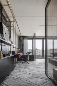 Modern office space with industrial design elements, featuring a sleek desk, comfortable chair, and minimalist decor.