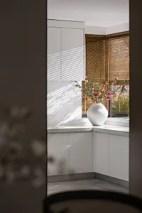 Modern minimalist kitchen with marble countertops and cabinets