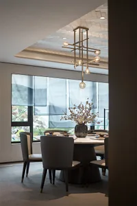Modern dining room featuring a metallic chandelier and minimalist design.