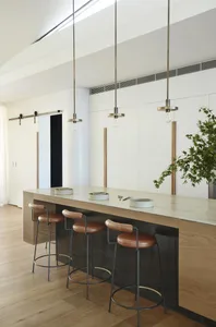 Modern kitchen with concrete countertops and leather stools
