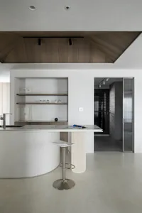 A modern kitchen featuring a white marble countertop and minimalist design.