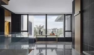 Modern interior design with a glass wall, showcasing contemporary living space.