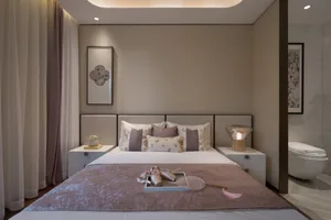 Modern minimalist bedroom with a bed featuring floral-patterned bedding, white and beige tones, and a floating bedside table 