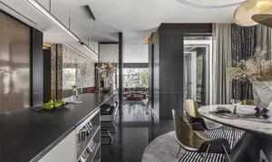 Modern residential kitchen featuring dark marble countertops and a black tile floor.