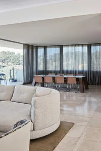 Modern sofa with fabric cushions on a polished marble floor in a residential interior setting.