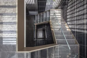 Modern staircase with concrete steps and glass railing