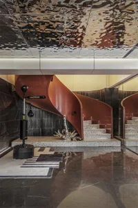 A modern interior design featuring a metal and marble staircase with a sleek, curved design.