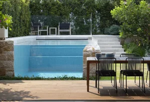 Modern outdoor residential area featuring wood, glass, and marble materials.
