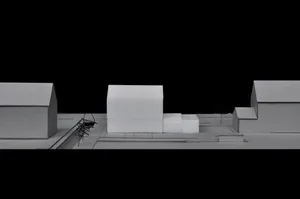 A minimalist building model constructed from cardboard.