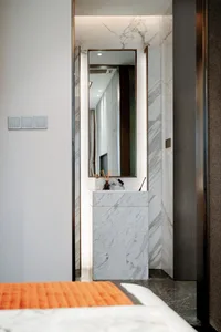 Modern bathroom featuring a sleek, minimalist design with white marble accents and a floating vanity.