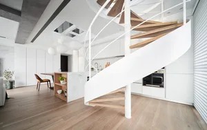 Modern kitchen featuring marble countertops and wooden stairs and boardwalk.