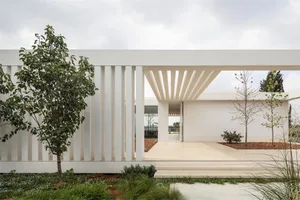 Modern minimalist house with concrete exterior and white canopy