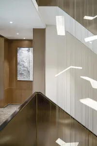 Modern office staircase featuring metal-clad banisters and paneling, with a sleek, contemporary design.