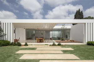 A modern residential house with concrete and glass materials.