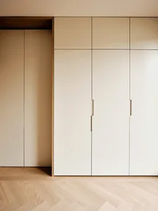 A minimalist closet with white doors made of wood and laminate materials.