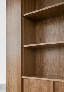 Modern bookshelf featuring wooden shelves and a sleek design.